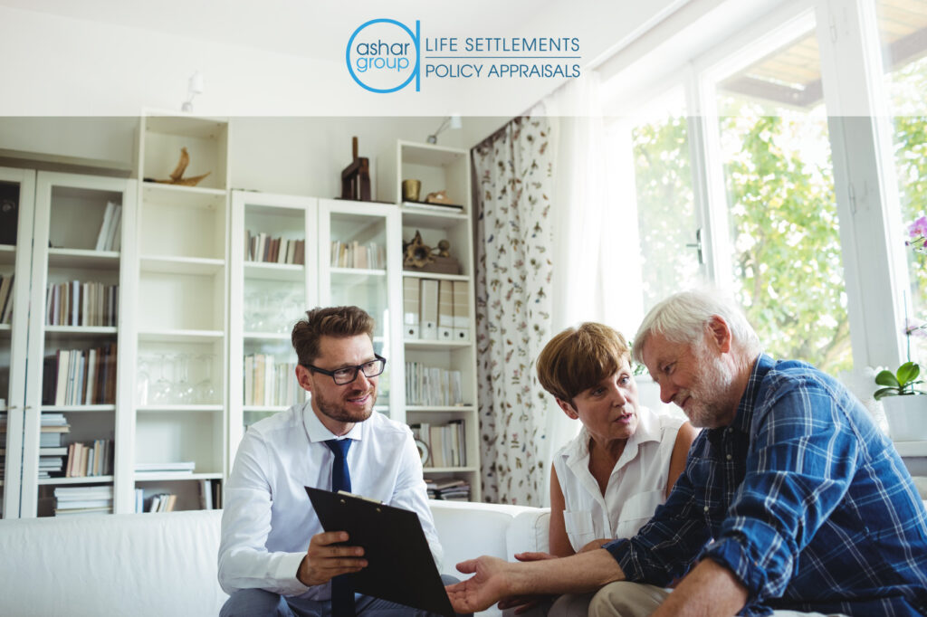 Financial advisor explaining life settlement to senior couple seated in their home